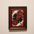 framed artwork of red and orang gerbera daisies in mahogany and black colored frame