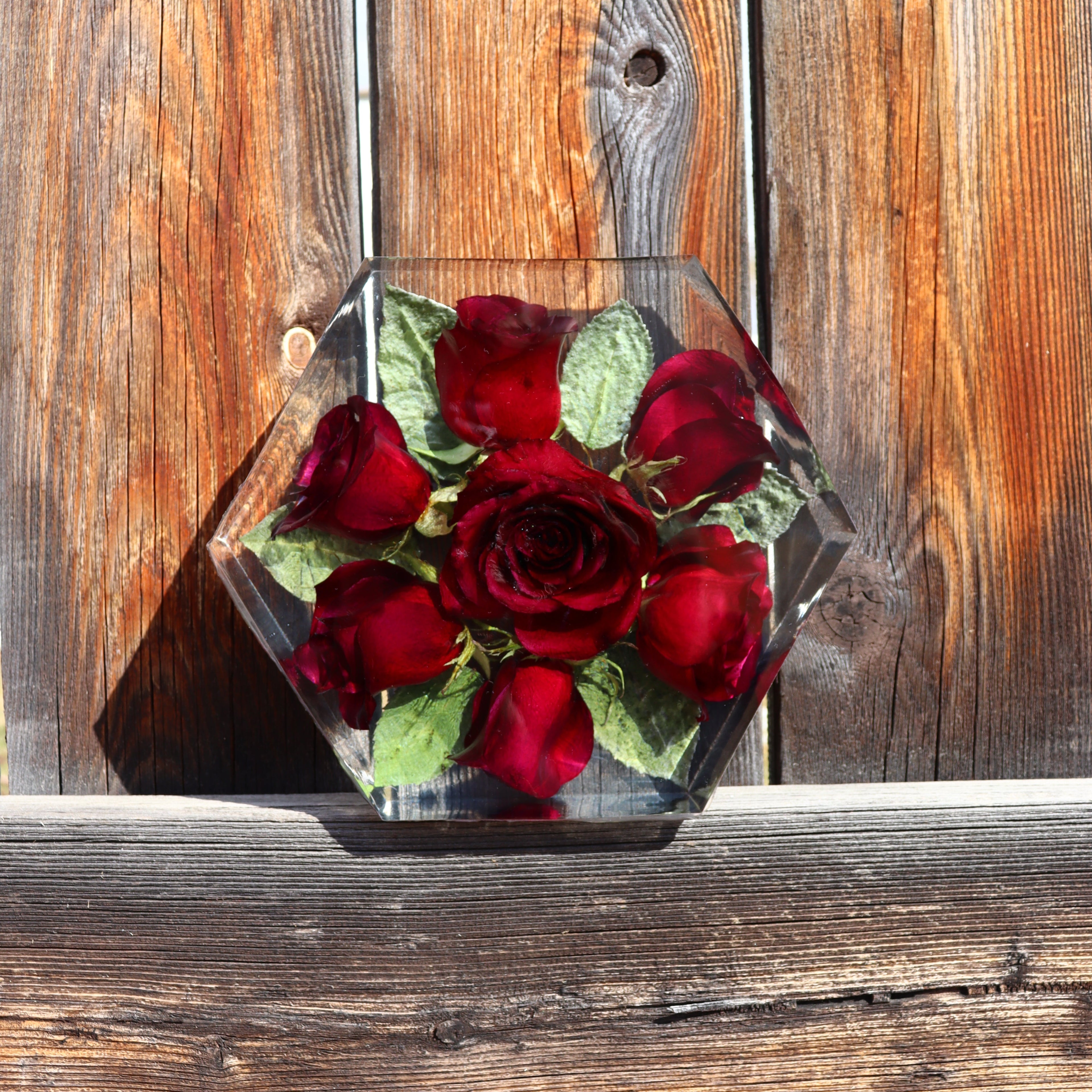 hexagon shaped resin rose arrangement with fence background